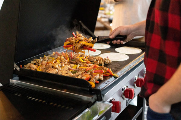 Camp Chef 4-Burner Flat Top 600 Grill and Griddle with Lid Lifestyle